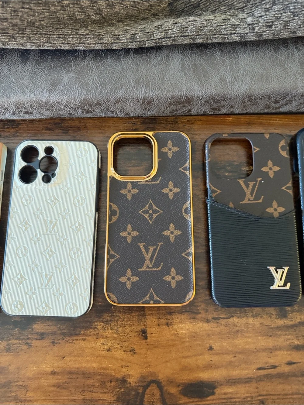5 - iPhone 14 Pro Max cases. The brown one to the left is a flaunt case.